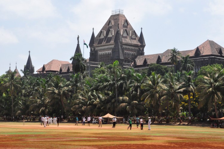 cricket being played @ Oval Maidan in front of the Bombay High Court
